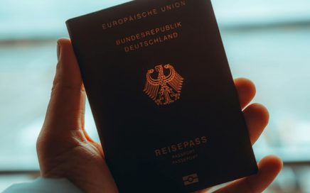 Close-up of a person holding a German passport, ideal for travel themes.