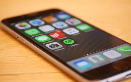 Close-up of a smartphone showcasing multiple app icons on its screen, representing modern technology and connectivity.