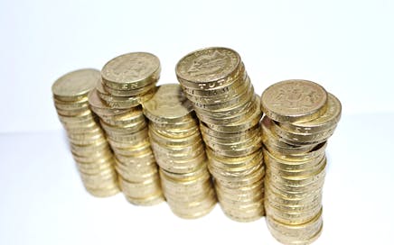 Close-up of stacked gold coins symbolizing wealth and financial growth.