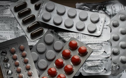 Close-up of various pills in blister packs showcasing medical and healthcare themes.