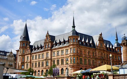Historic Gothic Revival building under a bright sky in Wiesbaden, Germany showcasing urban architecture.