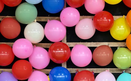 Vibrant balloons at a funfair stall, creating a cheerful atmosphere in Ascot Vale, Australia.